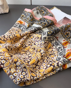 Close-up of retro floral paisley patterns on soft silk-like fabric with vibrant colors