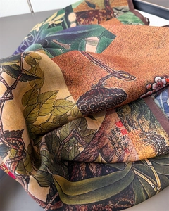 Macro shot of silk scarf showing high-quality twill texture and artistic lotus print
