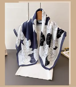 Detail of elegant navy blue camellia floral print scarf on lightweight summer fabric