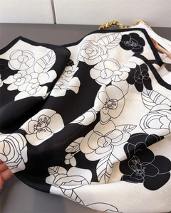 Detailed view of the herringbone texture and camellia print on this cotton-linen scarf