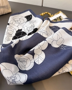 Close-up of herringbone texture silk scarf with black and white camellia floral pattern