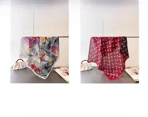 Detail showing floral and vintage carriage patterns on double-sided silk scarves
