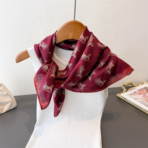 Burgundy silk scarf with vintage carriage print styled on a white knit vest