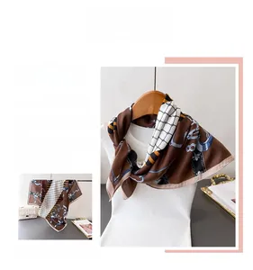 Close-up of vintage brown cotton-linen scarf with elegant blue chain and buckle patterns