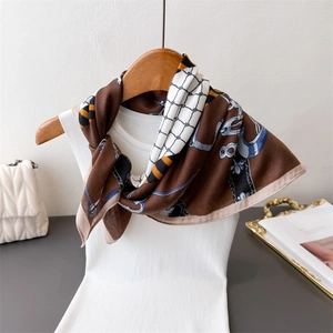 Equestrian chain print cotton-linen feel silk scarf on a wooden hanger with magazine