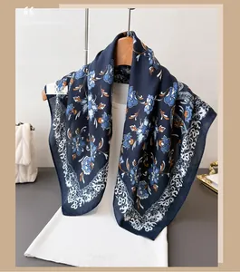 Detail view of dark blue floral cotton-linen scarf with retro lace patterns on wooden hanger