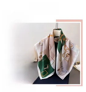 Detail of elegant retro equestrian style silk scarf with green and beige chain pattern