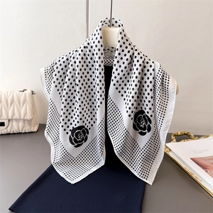 French style polka dot square scarf with camellia floral patterns hanging on a hanger