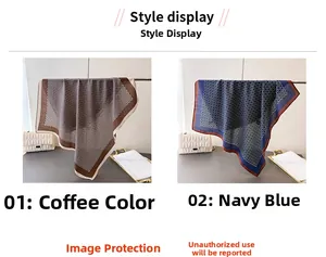 Detail of geometric pattern silk-like scarves in brown and navy blue on a luxury setup
