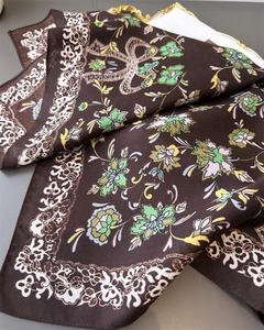 Detail of dark blue floral pattern and herringbone texture on soft silk square scarf