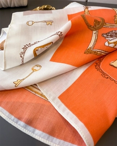 Detail of herringbone linen texture silk scarf with vintage key and frame patterns