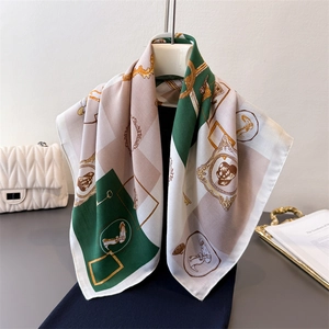 Elegant equestrian print silk scarf with emerald green and beige patterns on mannequin