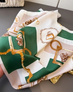 Detail of silk-like scarf with vintage illustration and green herringbone texture