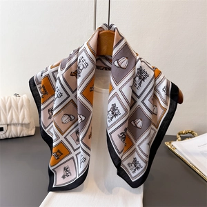 Carré de soie à motif chevrons et imprimé équestre élégant sur un cintre en bois