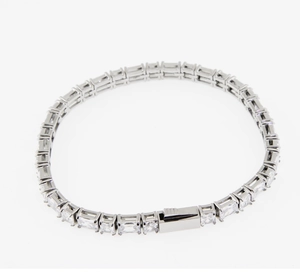 Macro detail of silver-tone tennis chain with rectangular cubic zirconia stones