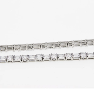 Detailed macro view of silver tennis chain with cubic zirconia and geometric metal link