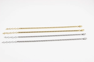 Détail de bracelets gourmettes réglables en acier inoxydable dorés et argentés