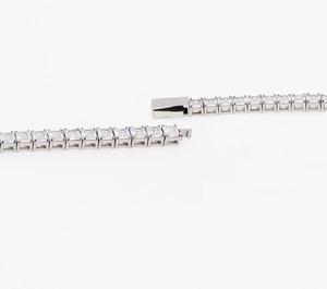 Detail of silver tennis bracelet showing secure box clasp and square-cut zircon stones