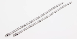 Detailed macro view of dual silver-tone tennis bracelets with square-cut cubic zirconia stones