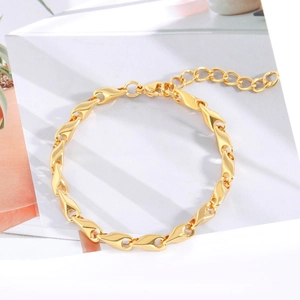 Détail d'un bracelet en titane doré avec maillons torsadés et un fermoir mousqueton