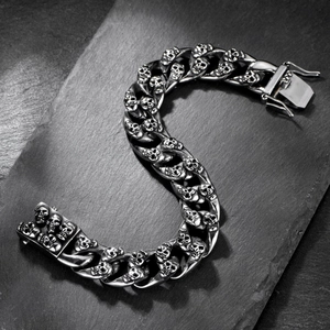 Close-up of double-row skull Cuban link bracelet in polished silver stainless steel