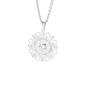 Detail view of silver hollow lotus pendant with a sparkling round zircon center