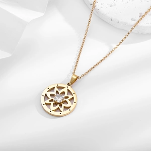 Detailed macro of gold titanium steel necklace with a hollow floral zircon pendant