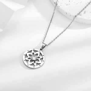Elegant stainless steel necklace featuring a hollow flower pendant with a sparkling center stone