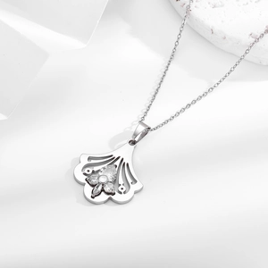 Silver ginkgo leaf fan necklace with sparkling stone inlay on a white pedestal