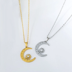 Detailed view of sun and moon pendants with cubic zirconia on gold and silver chains
