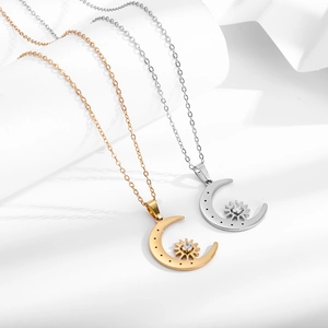 Detail view of gold and silver crescent moon necklaces with sparkling star zircon pendants