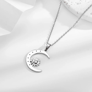 Titanium steel necklace with crescent moon and star zircon pendant on rock background