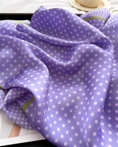 Close-up of purple polka dot silk scarf showing smooth texture and elegant draping
