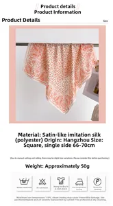 Detail view of paisley satin square scarf showing vibrant orange floral pattern and soft texture