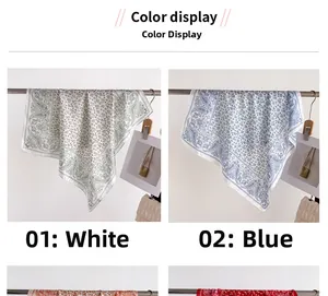 Detail view of paisley pattern silk square scarves in white and blue color options
