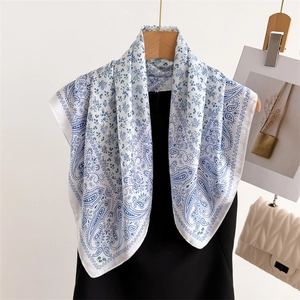 White paisley print silk square scarf with blue patterns and delicate floral details