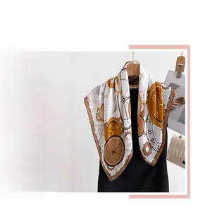 Macro view of vintage clock pattern on silk scarf with elegant brown rolled edges