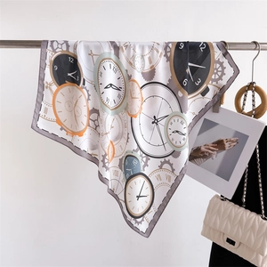 Detail of silk-like scarf draped on metal bar featuring vintage clock and gear prints