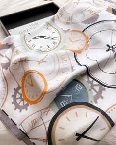 Detailed view of satin scarf showing vintage clock patterns and smooth texture