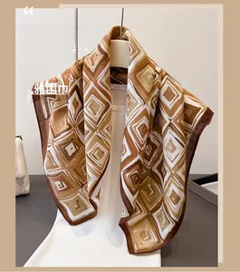 Detailed view of geometric herringbone scarf draped elegantly on a mannequin