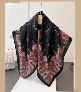 Detail of elegant black scarf with white polka dots and colorful paisley vintage pattern