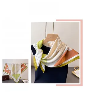 Detail of floral silk scarf showing elegant geometric patterns and floral motifs