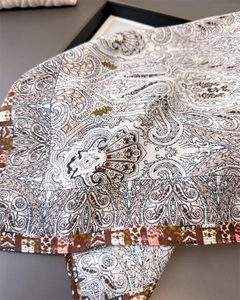 Macro detail of luxury paisley pattern on soft cotton-linen blend square scarf with border