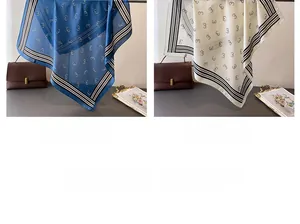Detailed view of navy and white satin scarves with geometric prints and striped borders