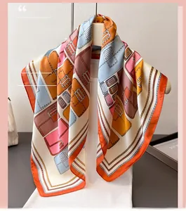 Close-up of geometric bag pattern silk scarf with elegant orange rolled edges