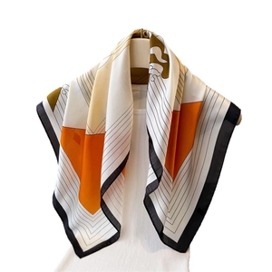 French style silk scarf with orange and yellow geometric blocks on a white vest