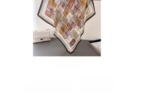 Detail of silk-like scarf with vintage handbag patterns and chic black borders