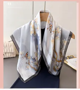 Detail of silk scarf with elegant floral and bird print hanging on a hanger