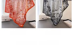 Detail of red and black floral silk scarves with botanical prints and elegant drape