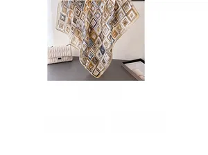 Detail of silk-like square scarf with geometric print in coffee and blue-grey tones